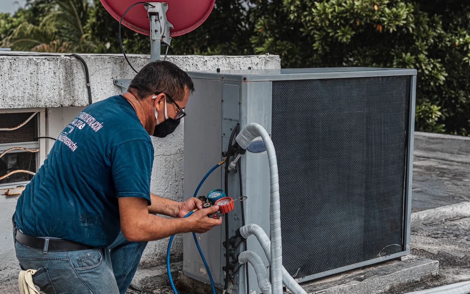 HVAC technician servicing an outdoor air-conditioning unit